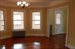 L-shaped living room with enclosed porch