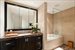 Spacious master bathroom featuring imported Italian marble, separate shower from tub, and integrated flat screen television