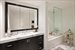 Spacious master bathroom featuring imported Italian marble, separate shower from tub, and intergraded flat panel television.