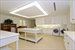 Oversized laundry room ont he lower level has a staff kitchenette