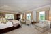 Gorgeous master bedroom with fireplace offers his and her master baths