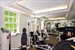 Fully equipped gym with outdoor shower overlooks the cabana and pool area