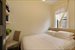 Bedroom with desk area and storage shelves