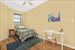 Second bedroom with ceiling fan and track lighting