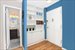 Entry foyer with built-in bookshelves, and bath