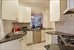 Windowed kitchen with granite counter tops.