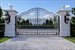 French lamp posts illuminate gated entrance