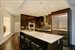 Open chef's kitchen with seating and ample storage