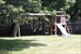 spacious back yard with play set