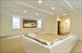 Future media room in lower level which features the media room, a powder room  and an ensuite bedroom/bath (virtually staged)