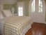 bedroom with balcony overlooking water view