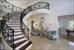 Marble floors and custom built stair case great you as you walk through the door