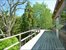 Second story 2 bedroom guest suite feature large treetop deck