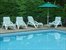 Corner deck of pool with loungers