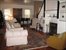 living room with fireplace and piano area