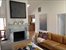 LIVING ROOM WITH FIREPLACE AND VAULTED CEILINGS